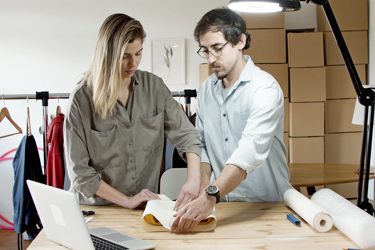 Team members packing orders in an online store's workspace, exemplifying efficient teamwork.